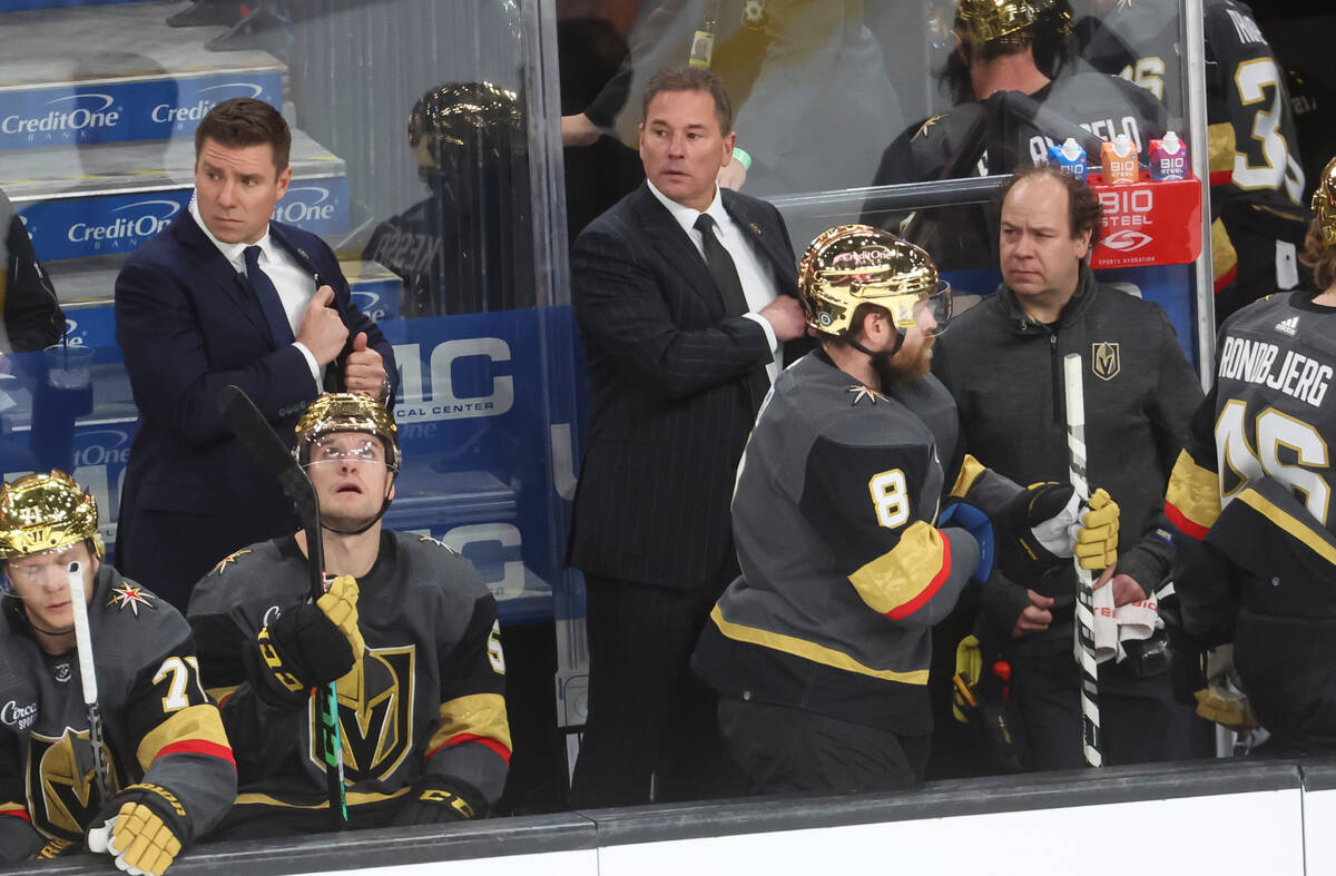 Golden Knights head coach Bruce Cassidy, center, looks on at the end of the first period of an ...