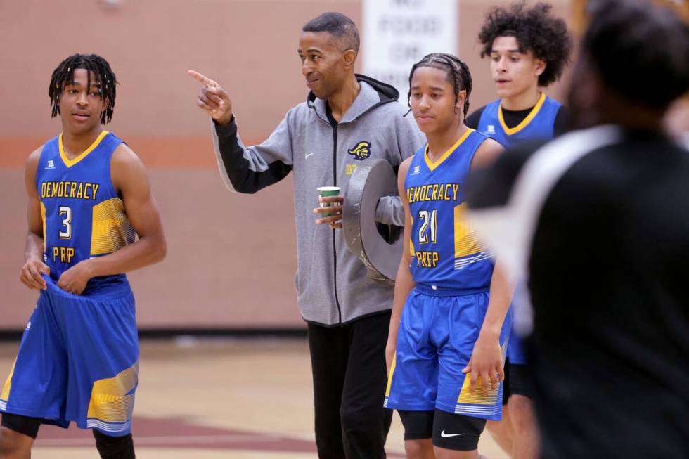 Democracy Prep assistant coach Mark Coleman with sons Tru Coleman, left, and Tai Coleman during ...