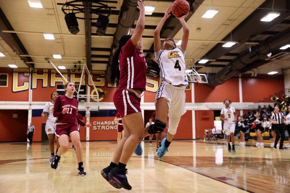 Clark's Anaya Williams (4) goes up for a shot under pressure from Desert Oasis' Jordyn Figueroa ...