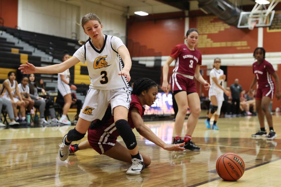 Clark's Charlotte Gillett (3) and Desert Oasis' Madison Pescado (23) fight for the ball during ...