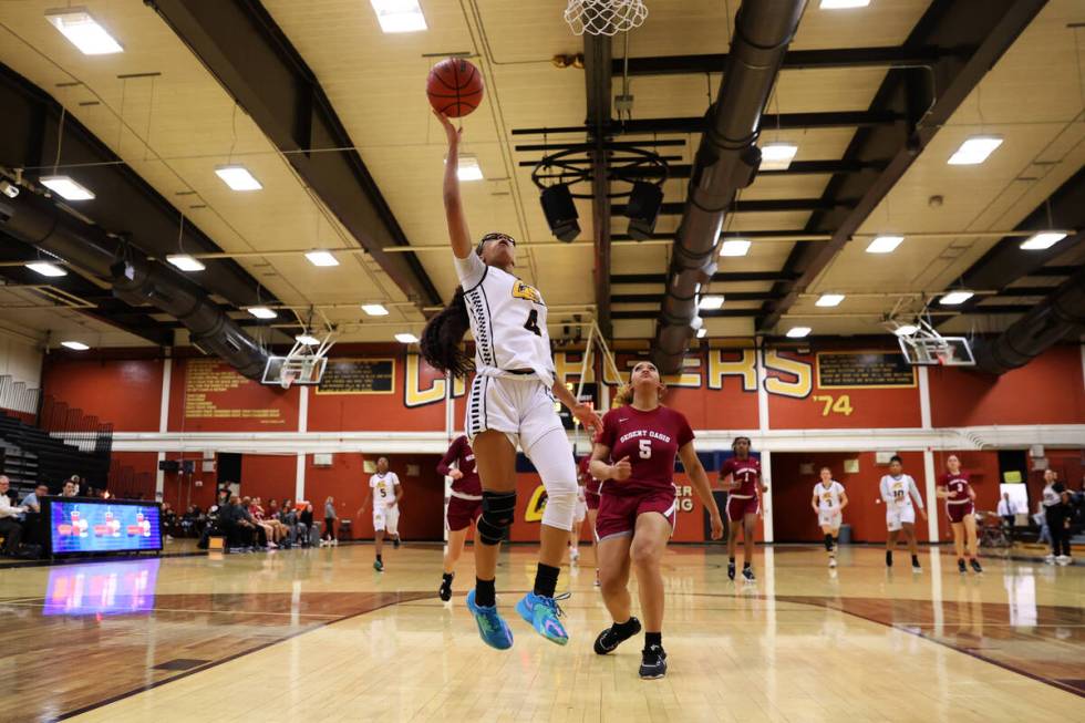 Clark's Anaya Williams (4) goes up for a shot under pressure from Desert Oasis' Devin Urbanski ...