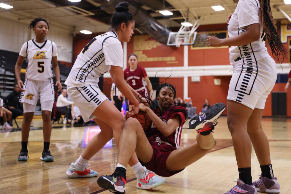 Desert Oasis' Madison Pescado (23) takes a fall while fighting for the ball against Clark's Tri ...