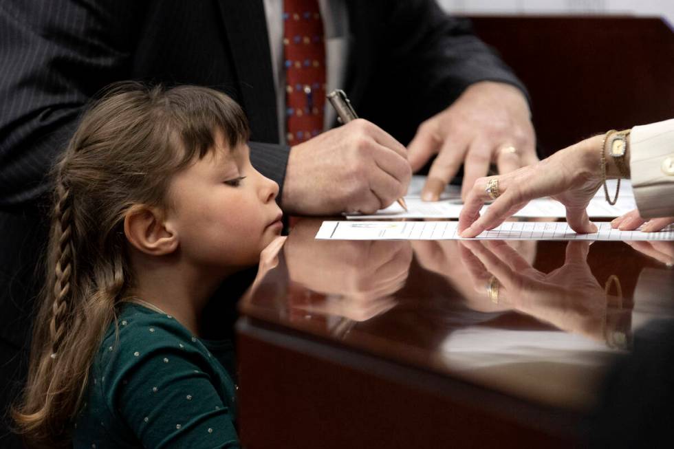 Ollie, a guest of Assemblyman Ken Gray, R-Dayton, watches as he signs his oath of office during ...