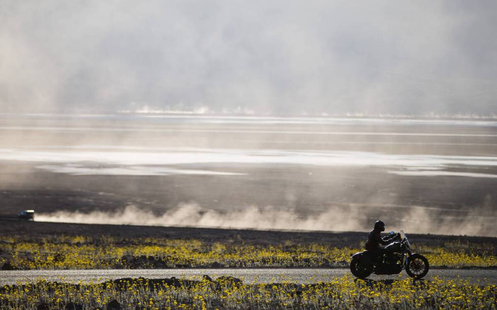 A motorcycle drives along Badwater Road in Death Valley National Park, Calif., on Saturday, Feb ...