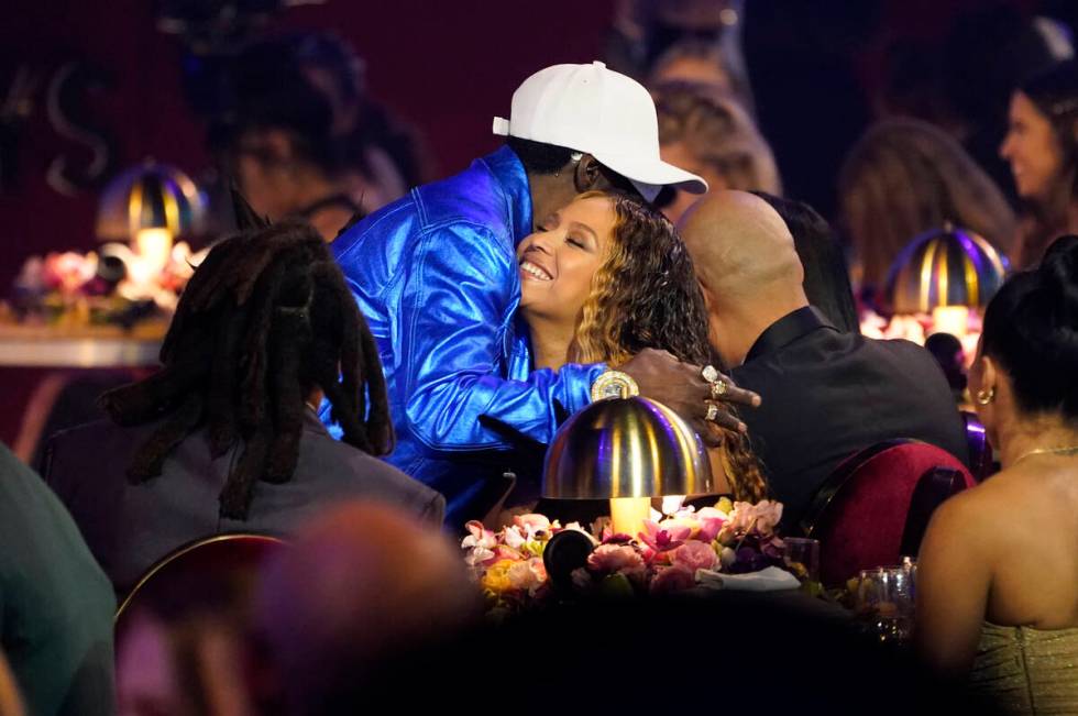 Flavor Flav, left, embraces Beyonce in the audience at the 65th annual Grammy Awards on Sunday, ...