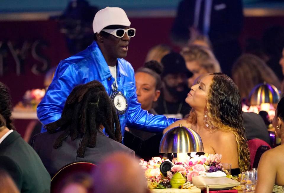 Flavor Flav, left, speaks with Beyonce in the audience at the 65th annual Grammy Awards on Sund ...