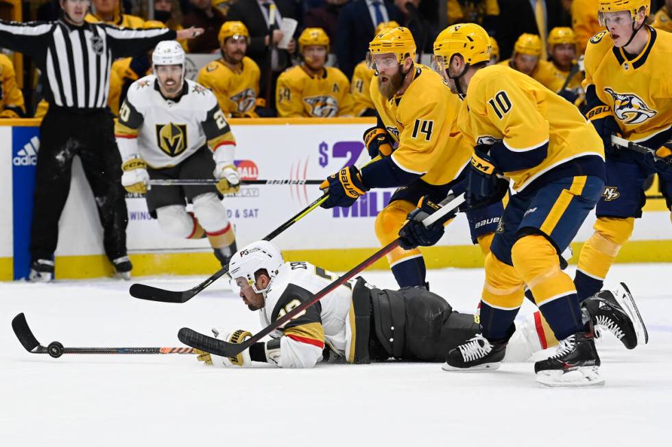 Vegas Golden Knights left wing William Carrier (28) pokes the puck away from Nashville Predator ...