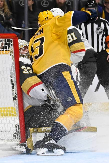 Nashville Predators center Yakov Trenin (13) collides with Vegas Golden Knights goaltender Adin ...