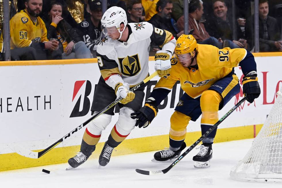 Vegas Golden Knights center Jack Eichel (9) moves the puck ahead of Nashville Predators center ...