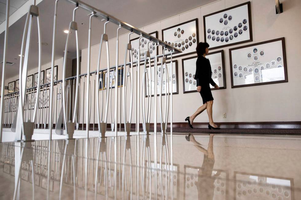 Sen. Heidi Seevers Gansert, R-Reno, walks past portraits of past Nevada Senate sessions during ...