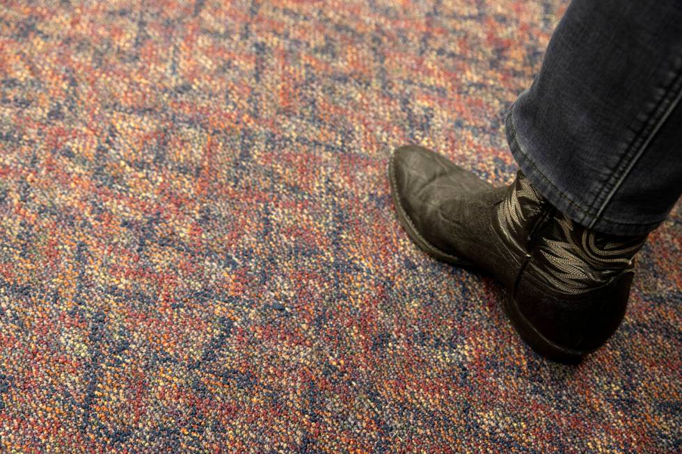 An attendee of a meeting of the Assembly Committee on Education wears cowboy boots during the 8 ...