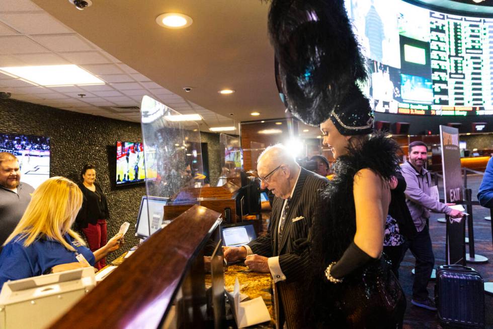 Oscar Goodman, former Las Vegas mayor, accompanied by showgirl Kristina Schiavi, places his ann ...