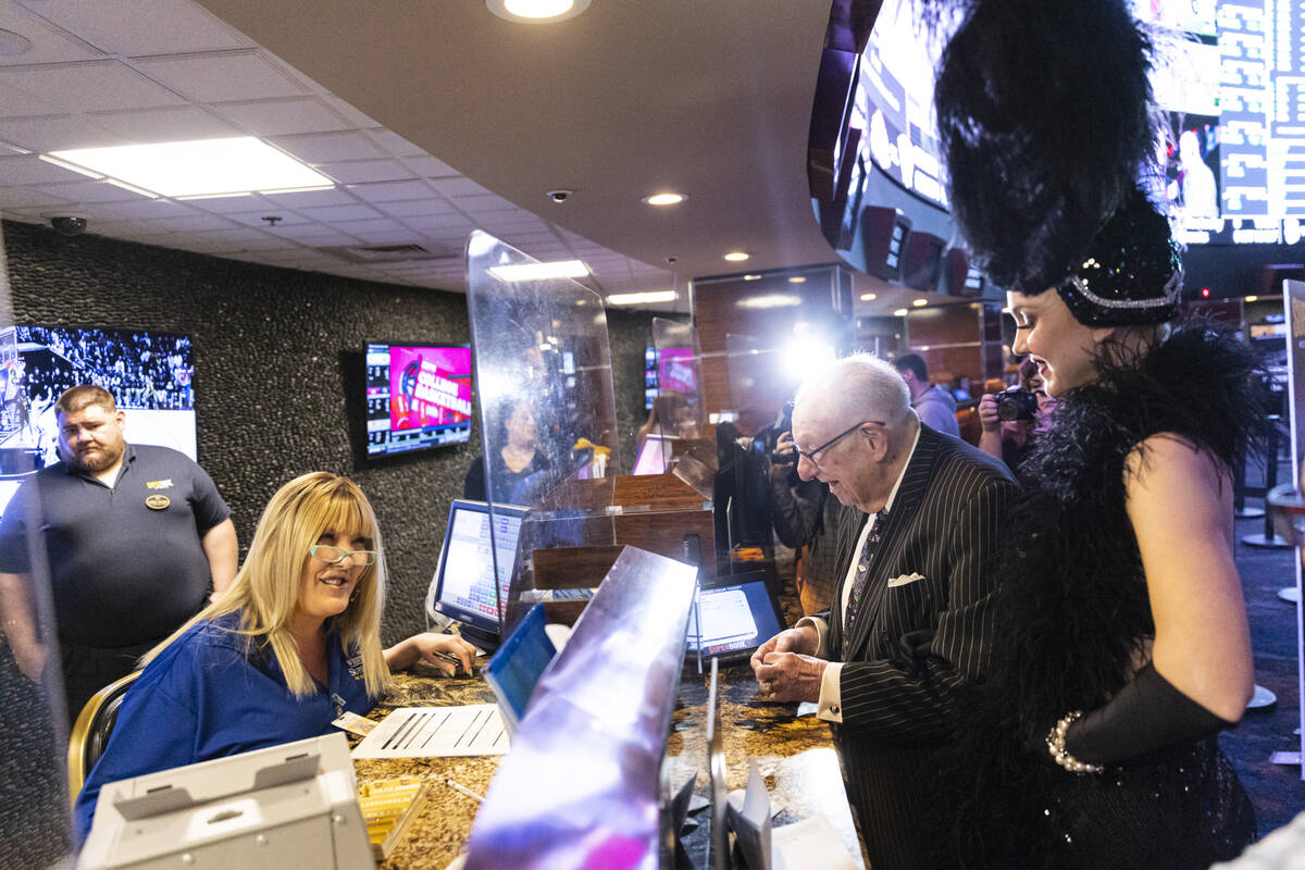 Oscar Goodman, former Las Vegas mayor, accompanied by showgirl Kristina Schiavi, places his ann ...