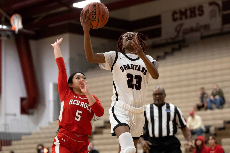 Cimarron-Memorial’s Dazani Graham (23) shoots against Doral’s Ryann Canda (5) dur ...