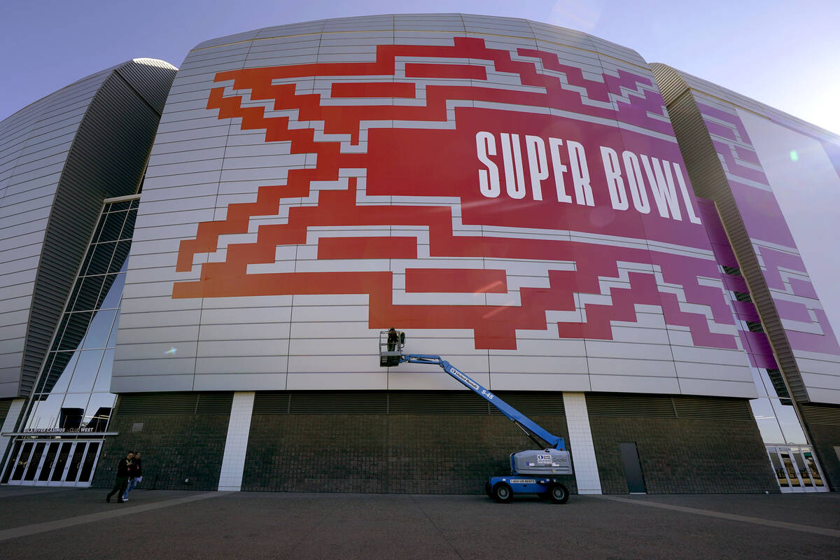 Workers prepare for the NFL Super Bowl LVII outside State Farm Stadium, Wednesday, Feb. 1, 2023 ...