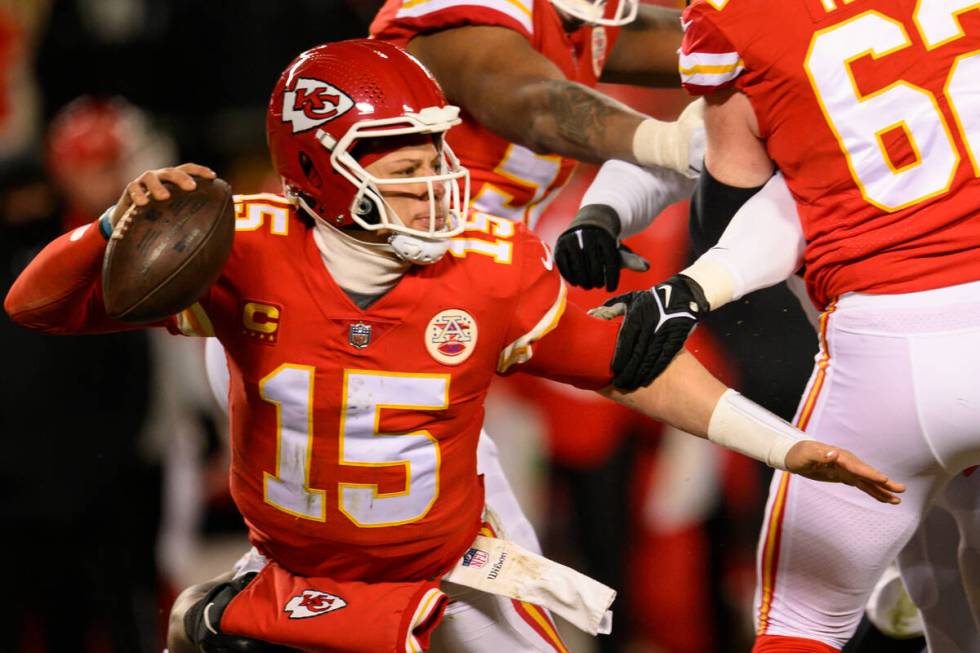 Kansas City Chiefs quarterback Patrick Mahomes (15) tries to escape pressure from the Cincinnat ...