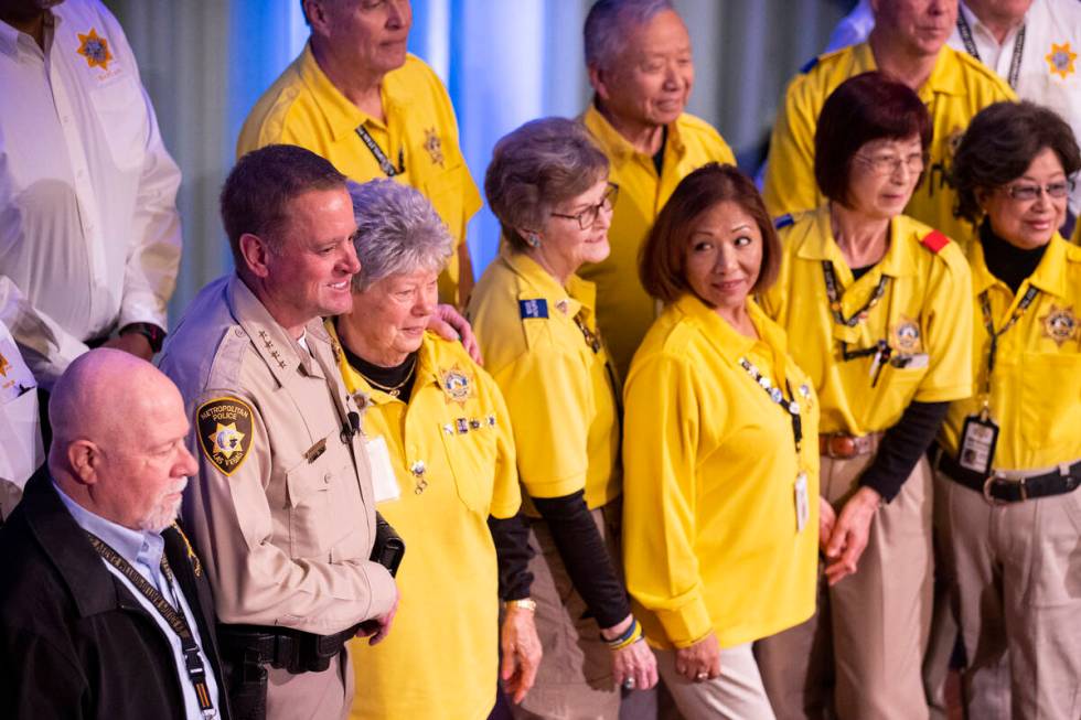 Sheriff Kevin McMahill, left, poses with volunteers, after delivering the State of the Departme ...