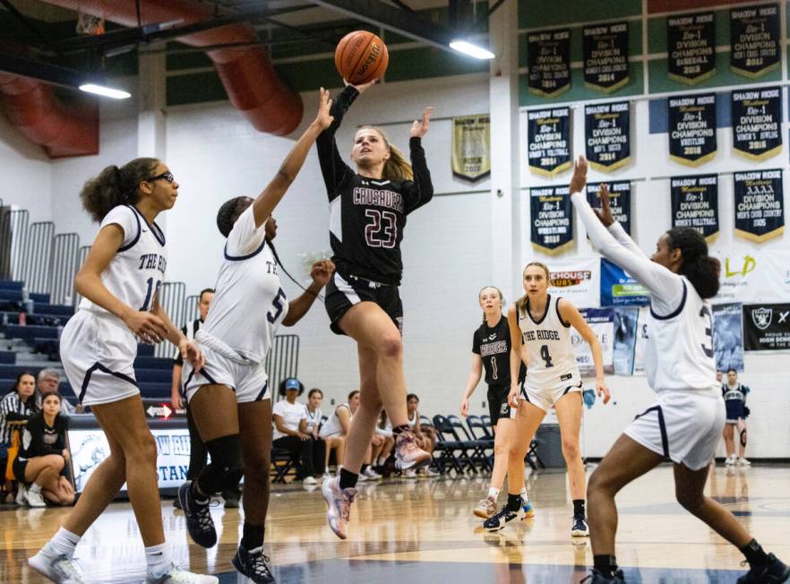 Faith Lutheran's Raina Forgue (23) shoots over Shadow Ridge's Zh'mya Martin (5) Jaslyn Jefferso ...