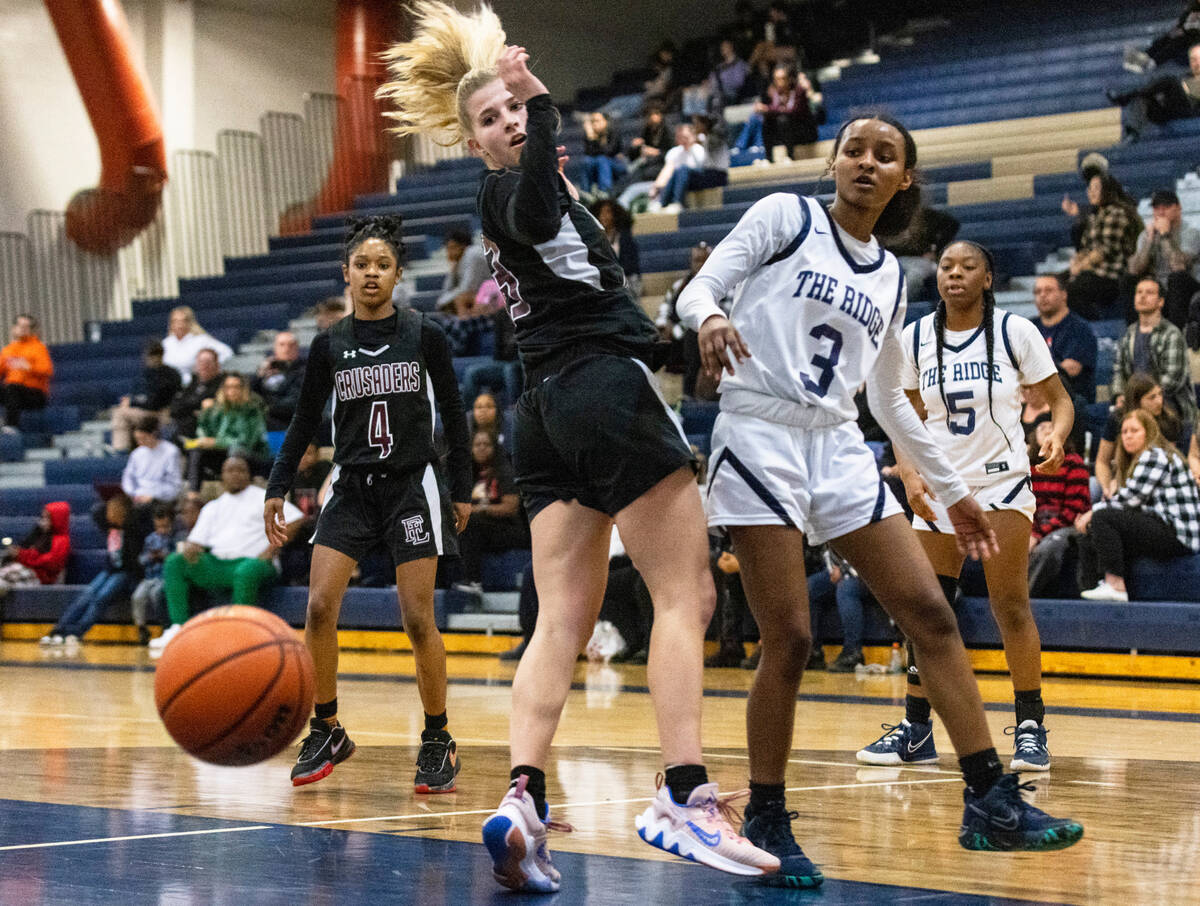 Faith Lutheran's Raina Forgue (23) and shoots over Shadow Ridge's Jordan Rutledge (3) watched ...