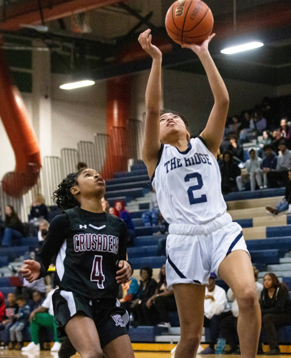 Shadow Ridge's Jasmine Mata (2) shoots for the basket as Faith Lutheran's Tamiah Harrison (4) d ...