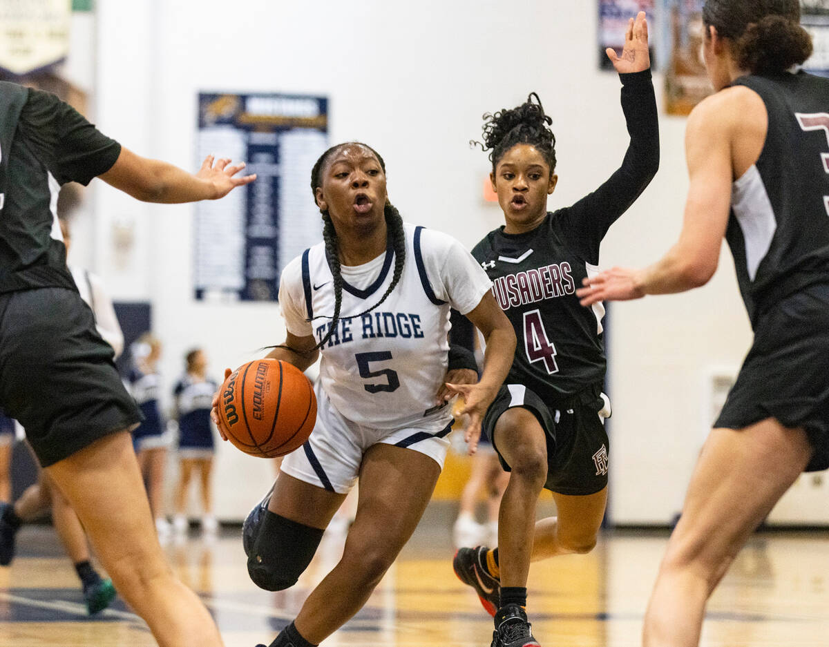 Shadow Ridge's Zh'mya Martin (5) drives past Faith Lutheran's Tamiah Harrison (4) during the fi ...