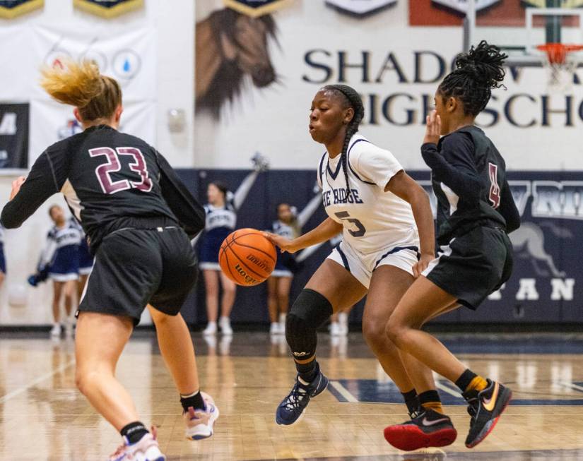 Shadow Ridge's Zh'mya Martin (5) surrounded by Faith Lutheran's Raina Forgue (23) and Tamiah H ...