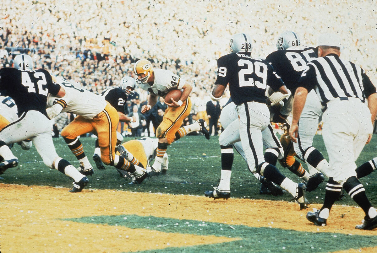 Green Bay Packers' Marv Fleming, #81, blocks Oakland Raiders' Bill Laskey, #42, to make way fo ...