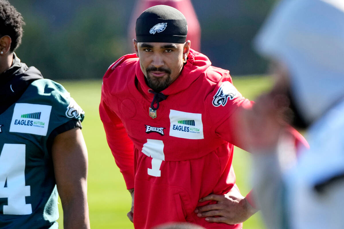 Philadelphia Eagles quarterback Jalen Hurts stretches during an NFL football Super Bowl team pr ...