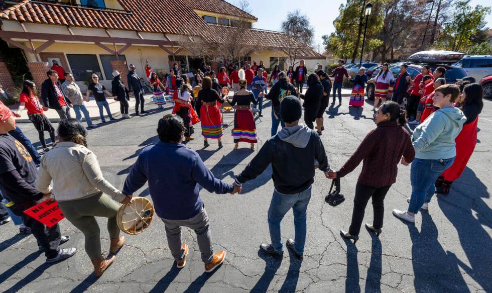 Members of the Native community and allies participate in a round dance as they gather in solid ...