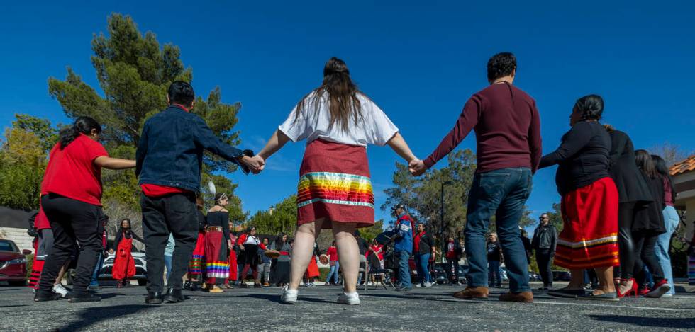 Members of the Native community and allies participate in a round dance as they gather in solid ...