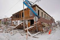 A corner building is damaged on Front Street in the historic district following an earthquake i ...