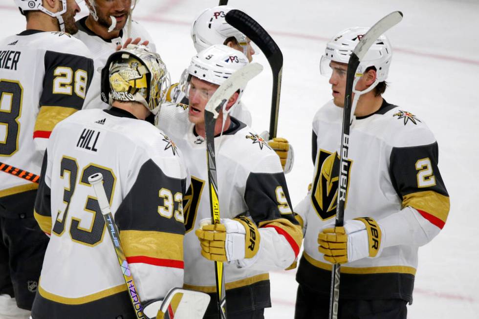 Vegas Golden Knights goaltender Adin Hill (33) is congratulated by center Jack Eichel (9) and d ...