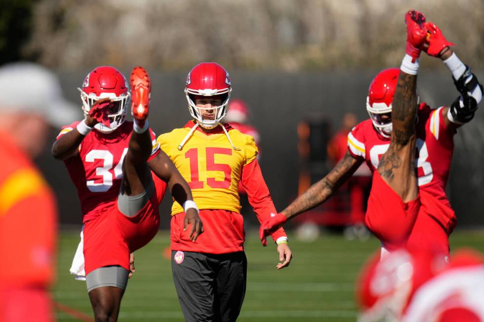 Kansas City Chiefs quarterback Patrick Mahomes (15) loosens up with running back Melvin Gordon ...