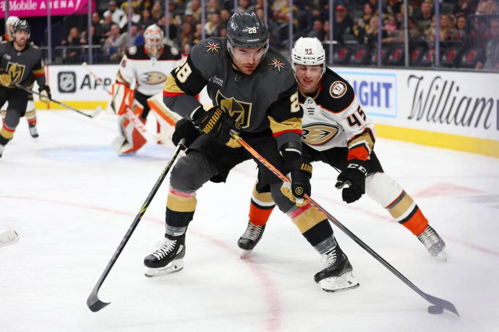 Vegas Golden Knights left wing William Carrier (28) fights for the puck against Anaheim Ducks d ...