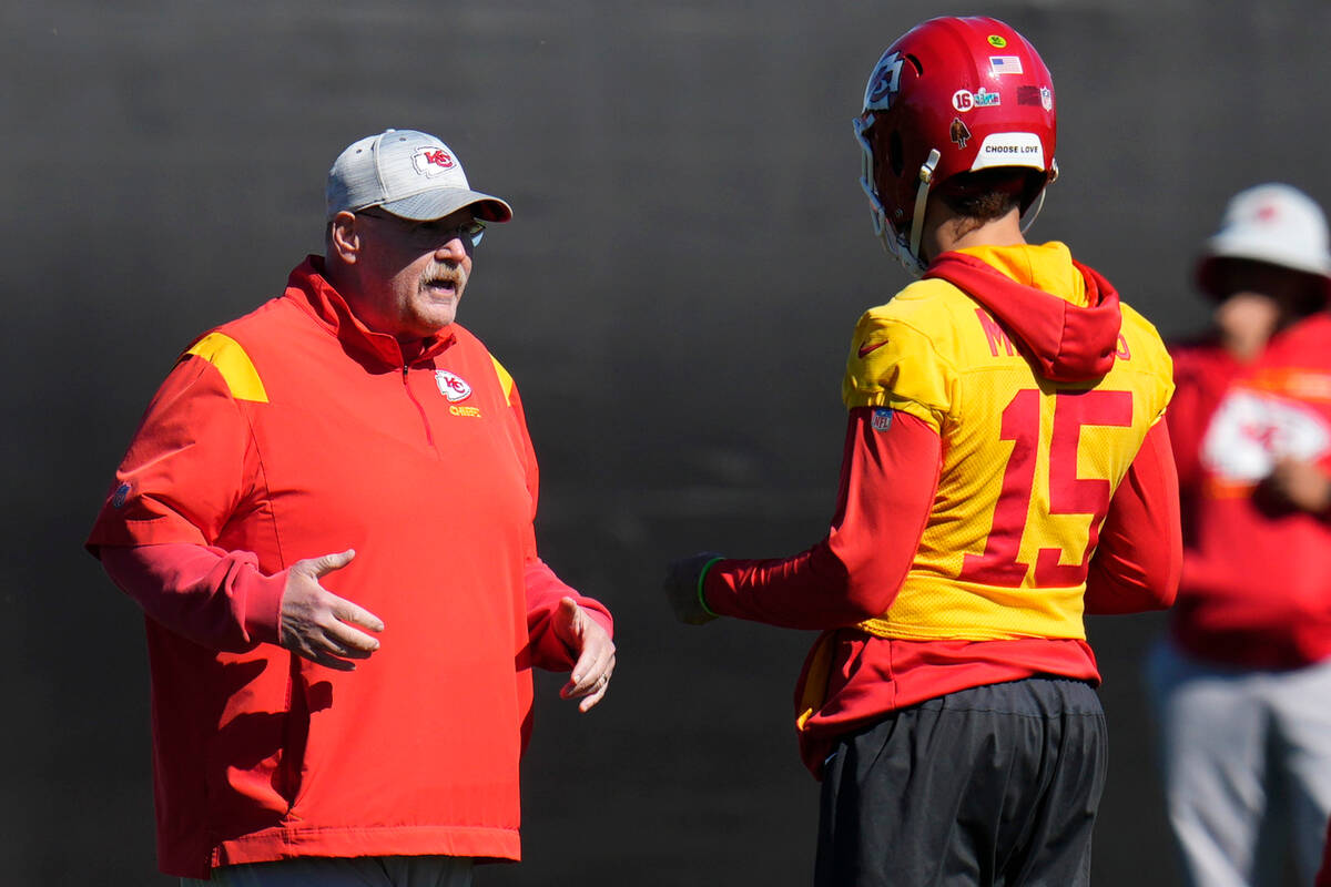 Kansas City Chiefs head coach Andy Reid, left, talks with quarterback Patrick Mahomes (15) duri ...