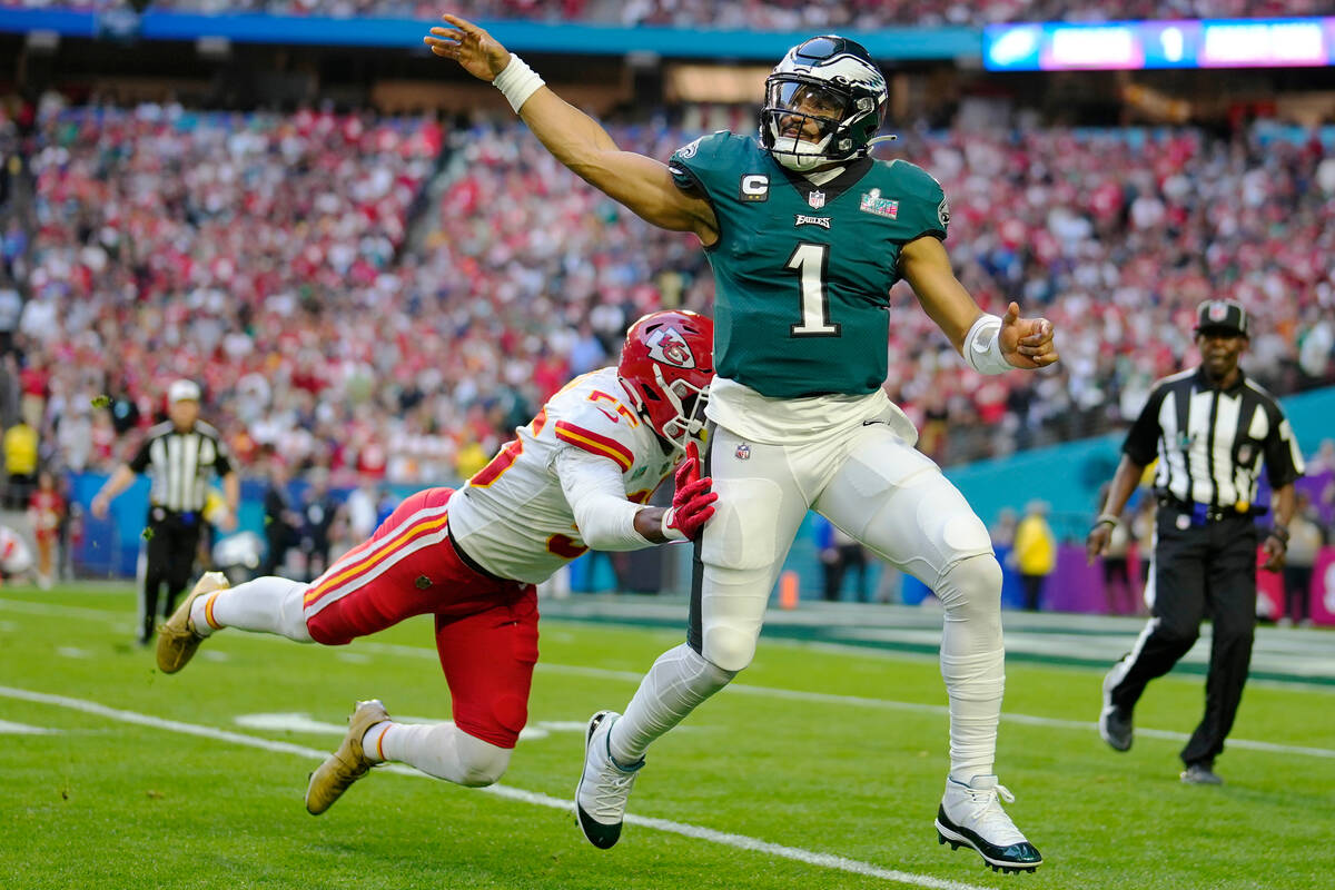 Philadelphia Eagles quarterback Jalen Hurts (1) passes under pressure during the first half of ...