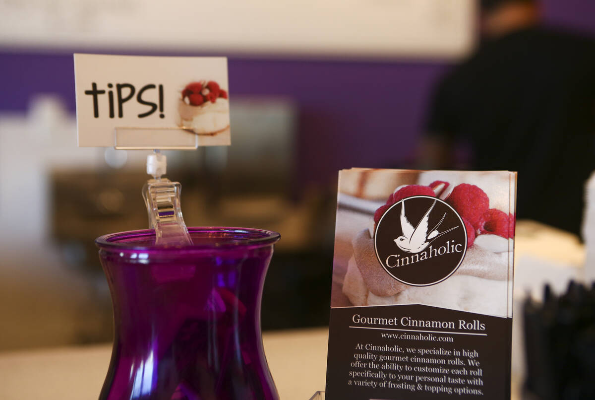 A tip jar is displayed next to menus at Cinnaholic in Las Vegas in 2016. (Chase Stevens/Las Veg ...