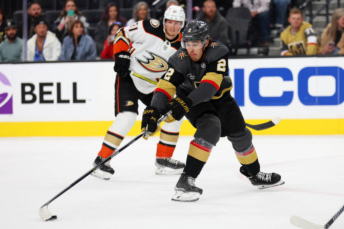 Vegas Golden Knights defenseman Zach Whitecloud (2) reaches for the puck as Anaheim Ducks cente ...