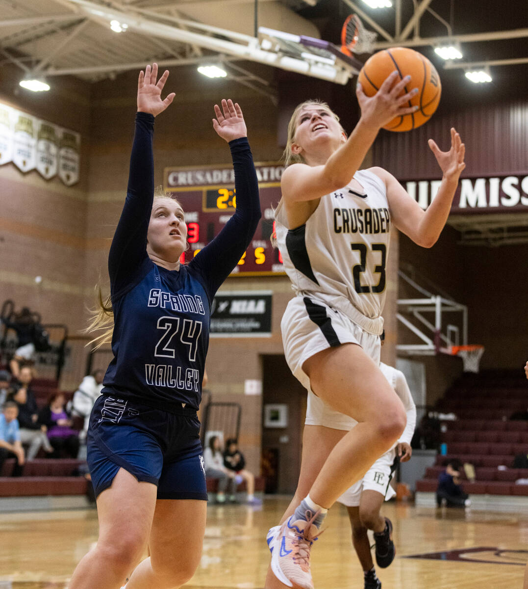 Faith Lutheran's Raina Forgue (23) shoots for the basket as Spring Valley's high Delaney Bartl ...