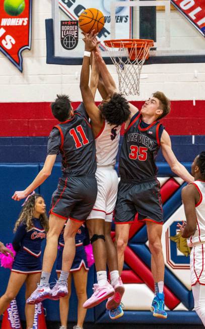 Coronado's Lantz Stephenson (5) fights for a rebound with Arbor View's Ridge Adams (11) and Arb ...