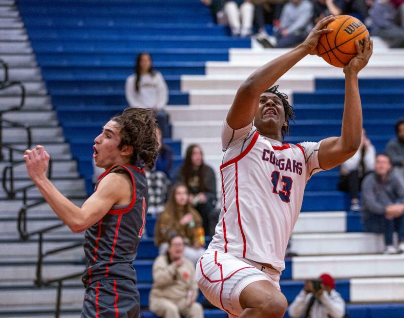 Coronado's Tee Bartlett (13) grabs a rebound as Arbor View's Maximus Romero (1) arrives late du ...