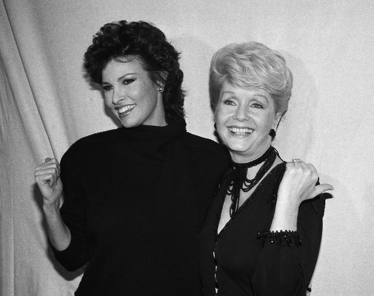 Debbie Reynolds, right, poses backstage with Raquel Welch after Welch's performance in "Woman o ...