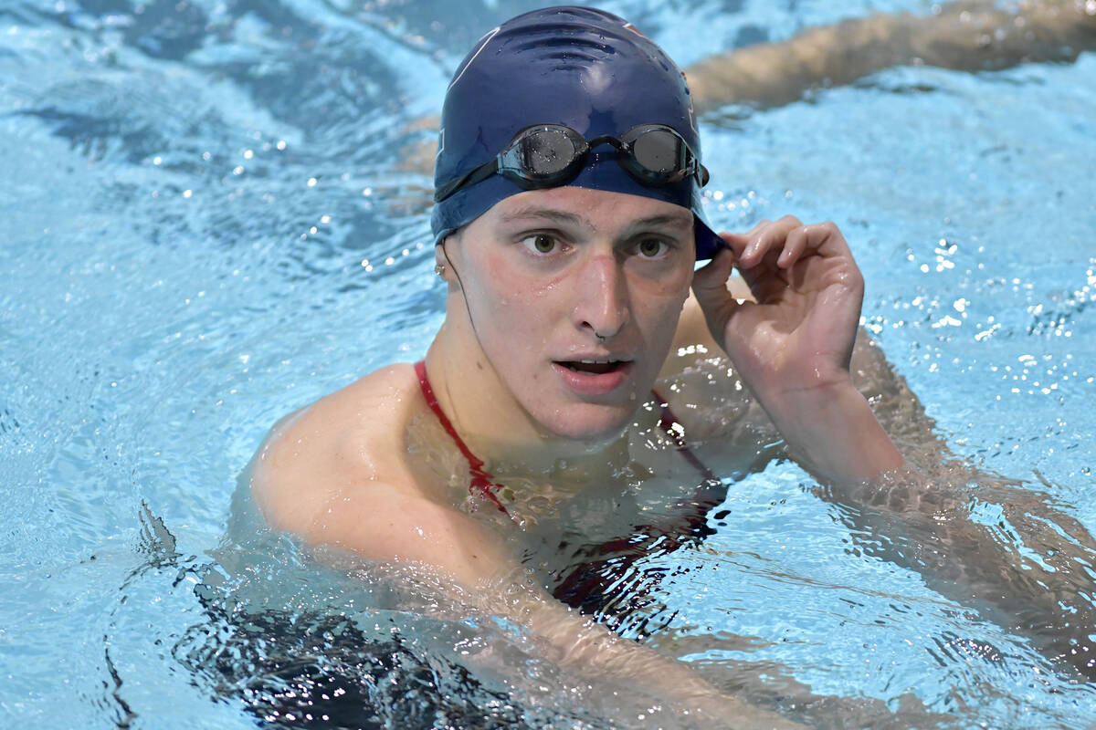 Transgender swimmer Lia Thomas speaks to her coach after winning the 500 meter freestyle during ...