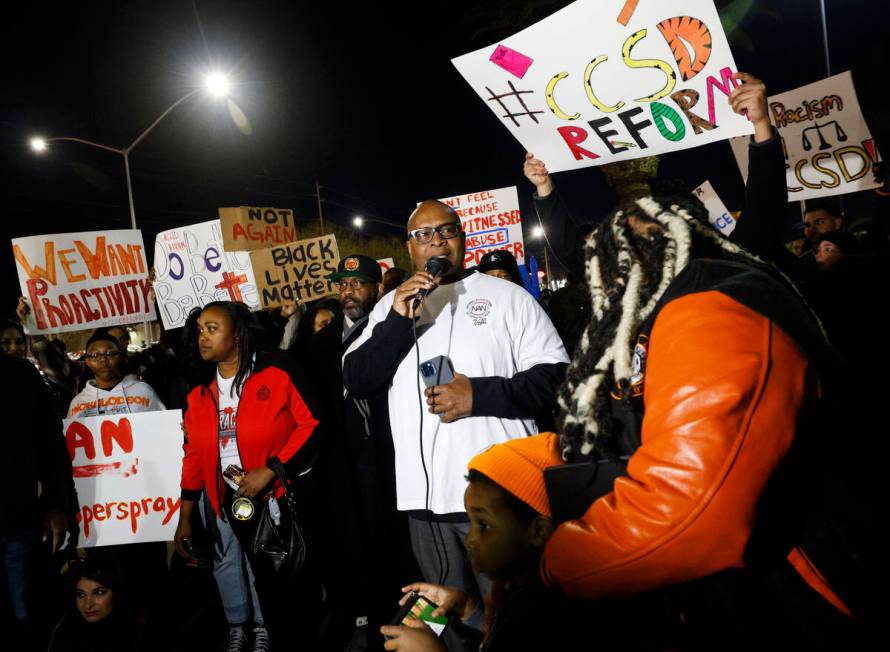 Robert Bush, president of National Action Network, center, speaks during a rally outside the Cl ...