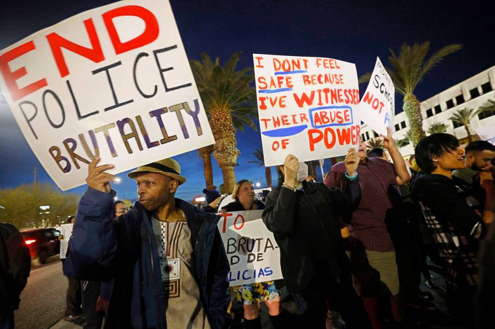 Protesters including Bernard Walker of Las Vegas, left, hold signs outside the Clark County Sch ...