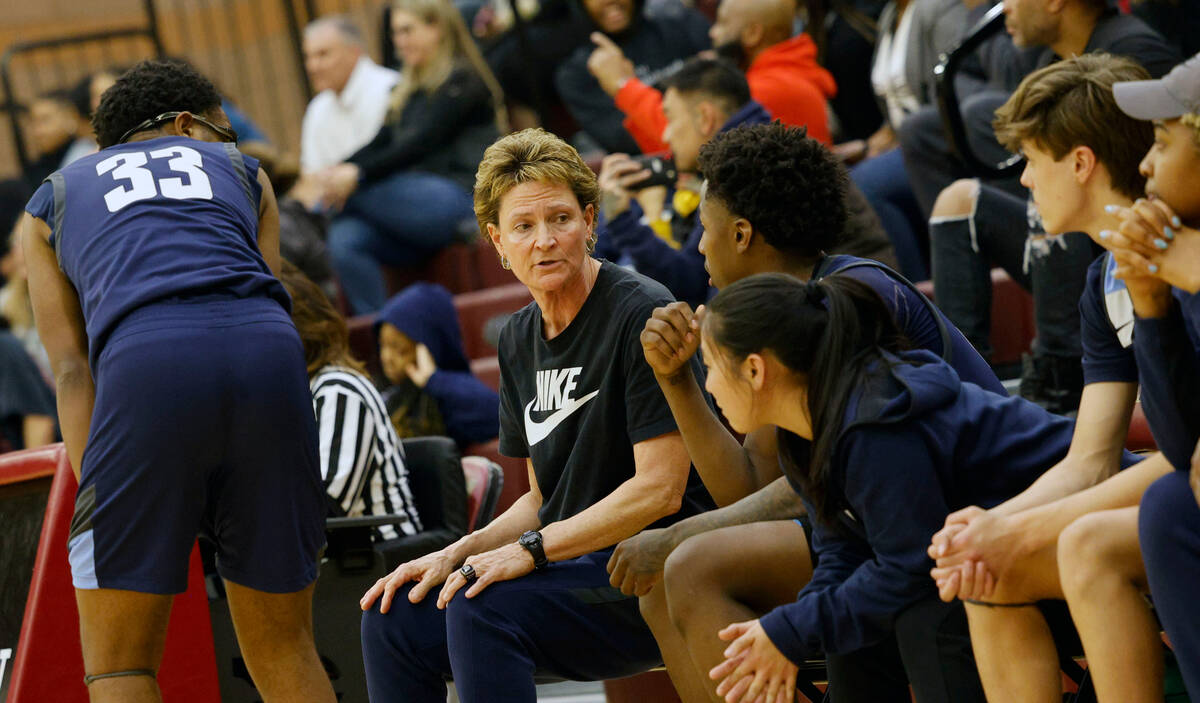 Centennial's head coach Karen Weitz, second from left, talks to her players during the first ha ...