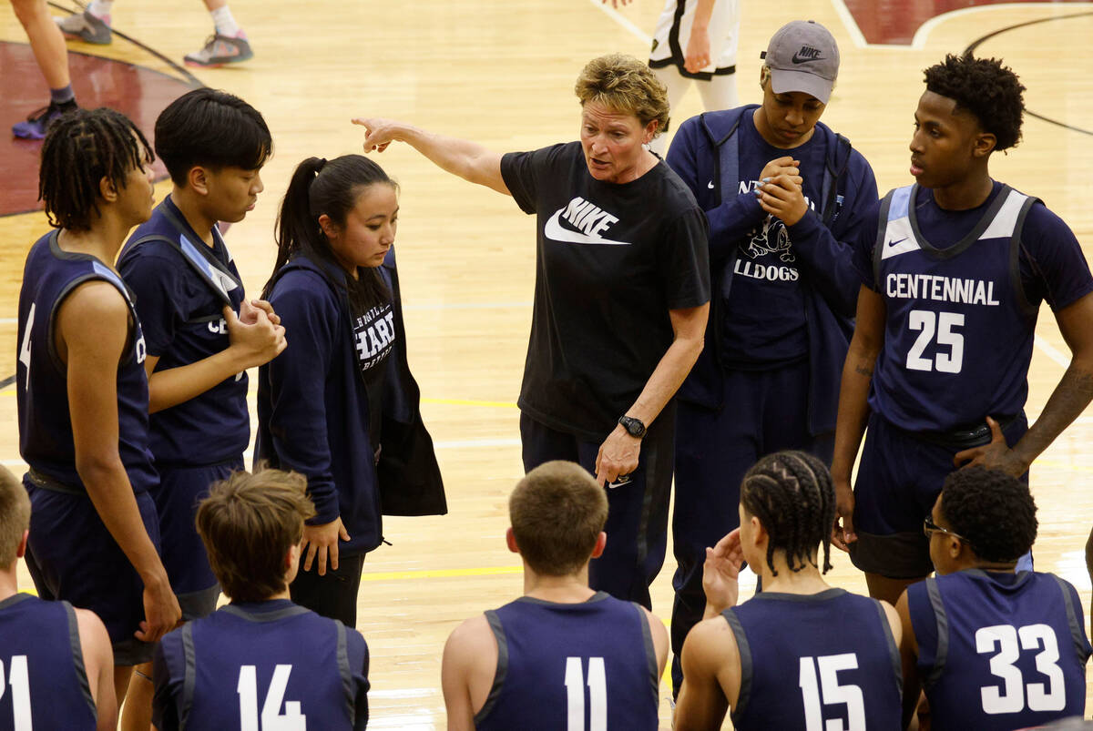 Centennial's head coach Karen Weitz, second from left, talks to her players during the first ha ...