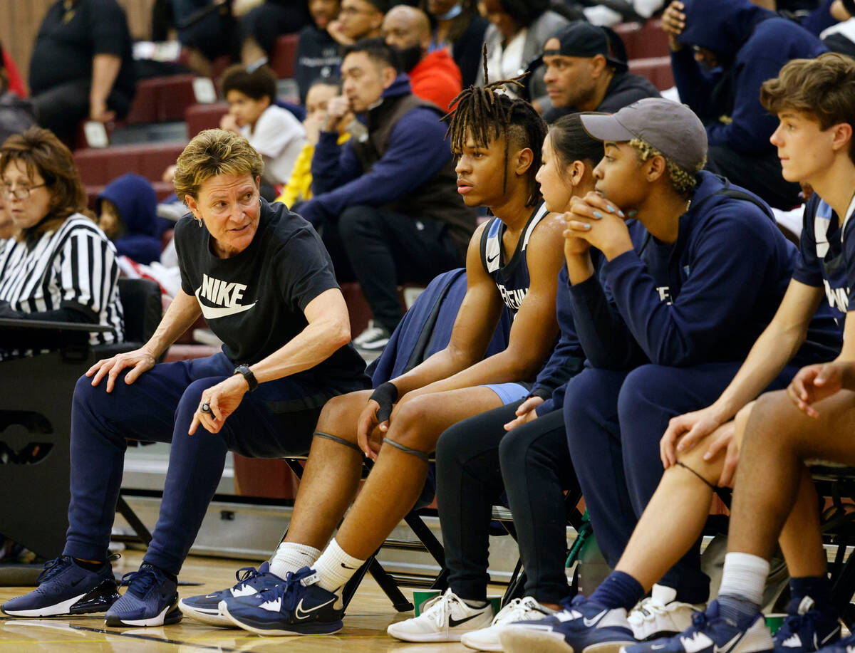 Centennial's head coach Karen Weitz, second from left, talks to her players during the second h ...