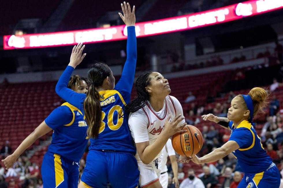 UNLV Lady Rebels forward Alyssa Brown, center right, fights toward the hoop while San José ...
