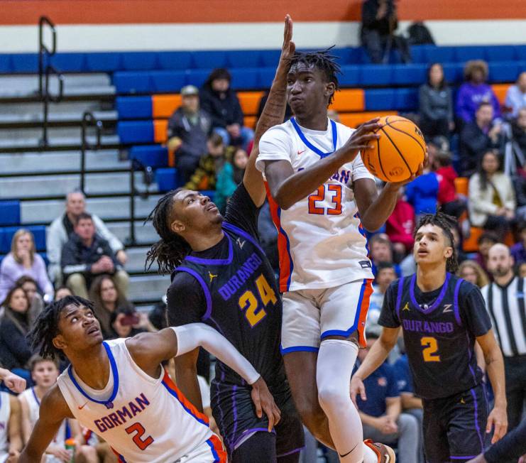 Bishop Gorman's Chris Nwuli (23) looks for a shot over Durango's Taj Degourville (24) with tea ...